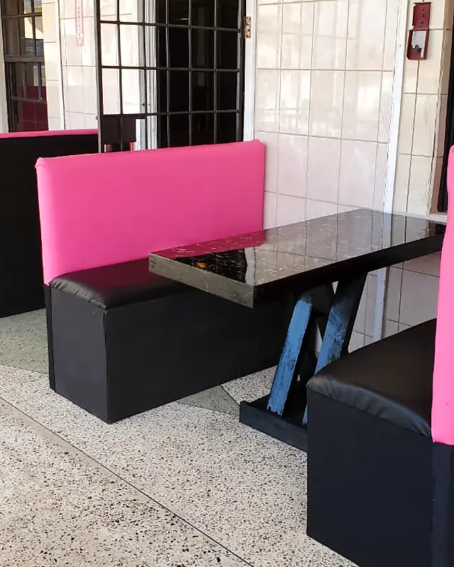 Pink and black padded restaurant booth with a black marble-look table – Lynn's Furniture