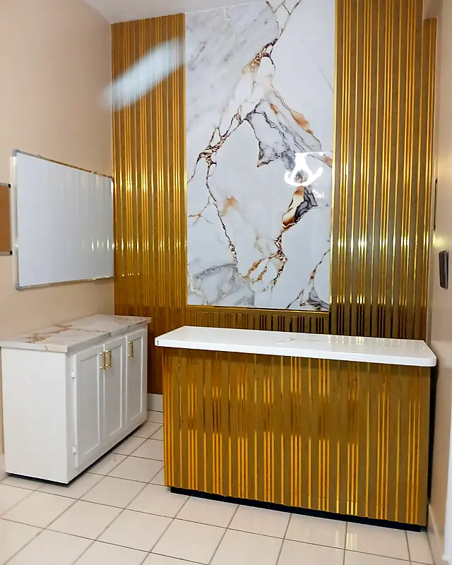 Reception counter with a gold slat front and white top in a finished office – Lynn's Furniture