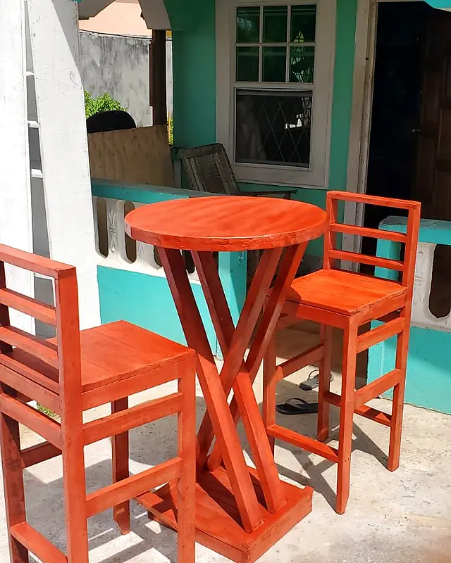 Round orange bar table with a crossed-leg base and two high bar chairs – Lynn's Furniture